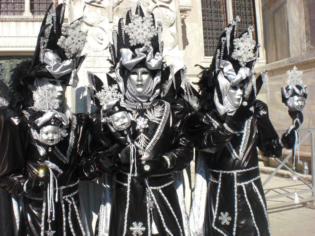 A group of people dressed in black and silver costumes.