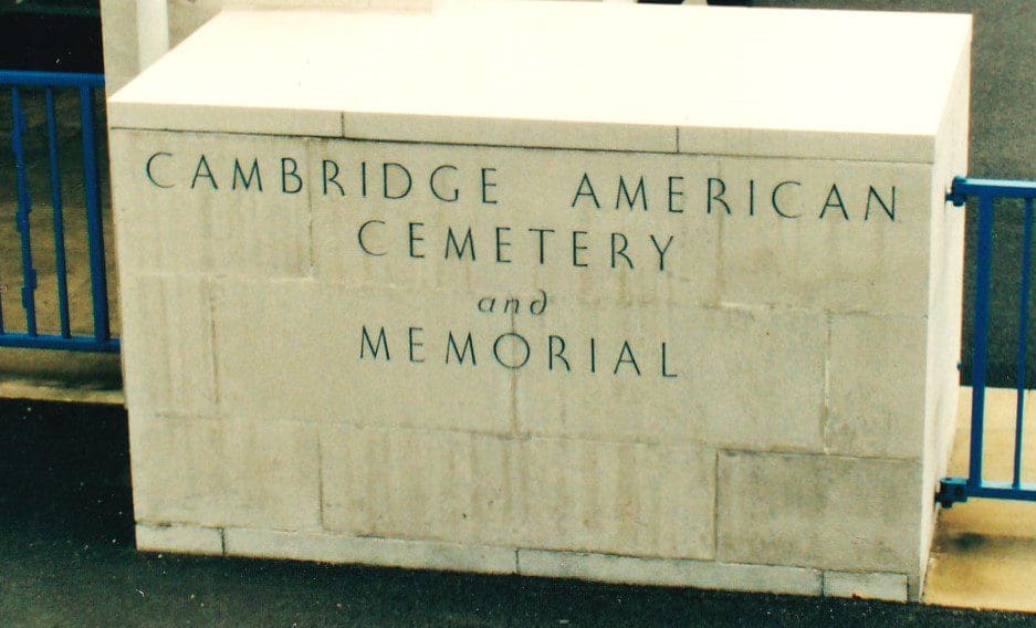 A stone sign that says cambridge america cemetery and memorial.
