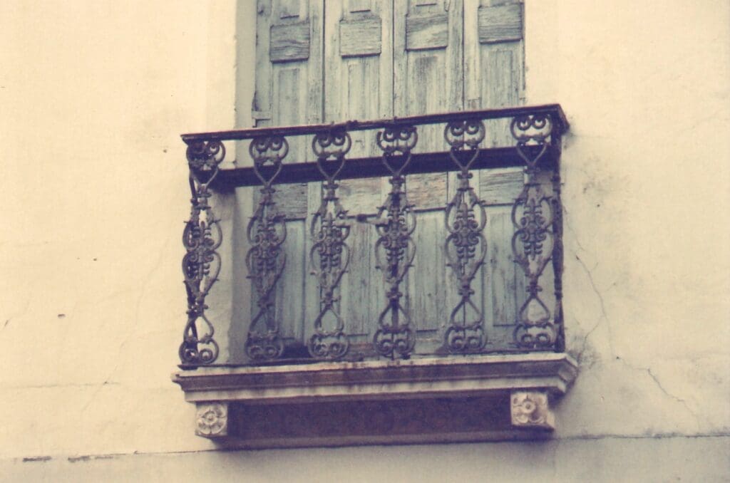 A small balcony or a window with wooden doors