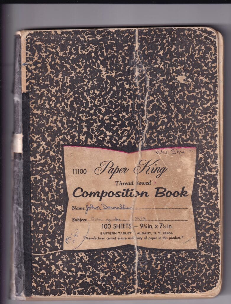 An old marbled cover composition notebook titled "Donnellan's Diaries" with a sewn binding.