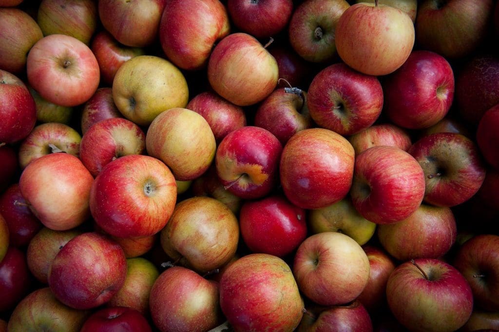 A pile of red apples with varying hues.